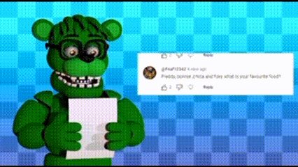 a green teddy bear is holding a piece of paper in his hands .