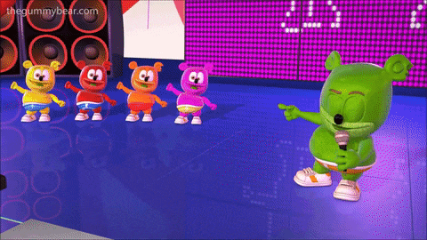 a group of gummy bears are dancing on a stage with the gummybear.com website in the corner