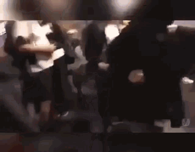 a group of people are dancing in a dark room in a club .