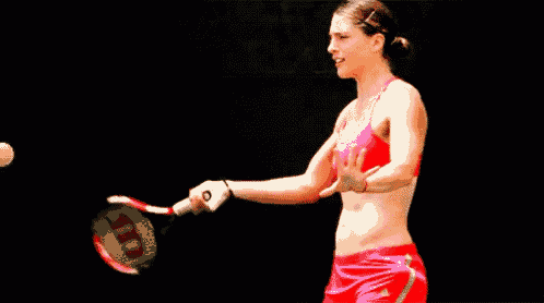a woman is holding a wilson tennis racquet