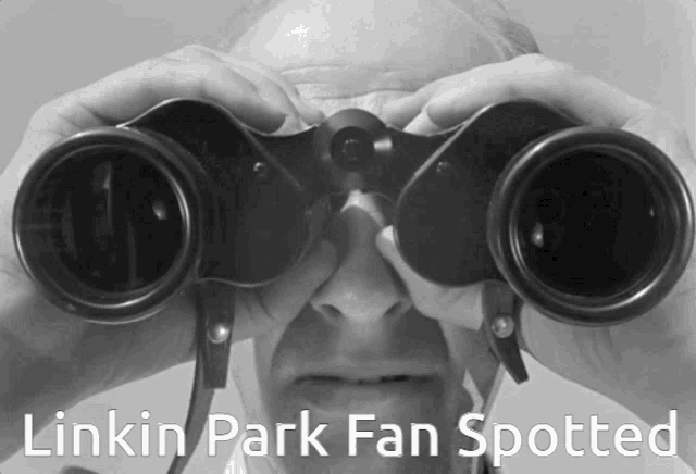a man looking through binoculars with the words " linkin park fan spotted " below him