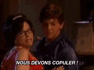 a man and a woman are dancing and the words nous devons copuler are above them