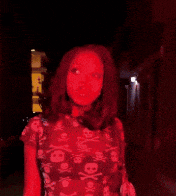 a woman in a blue shirt with skulls on it