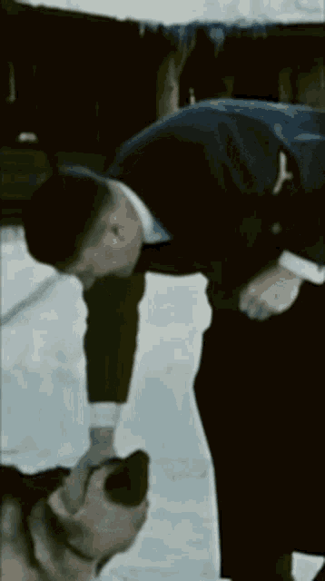 a man in a suit is petting a dog