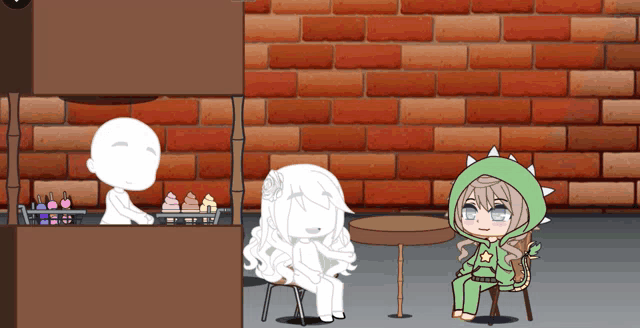 a girl in a green dinosaur outfit sits at a table