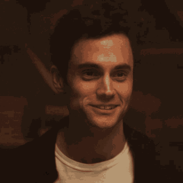 a close up of a man 's face with a smile