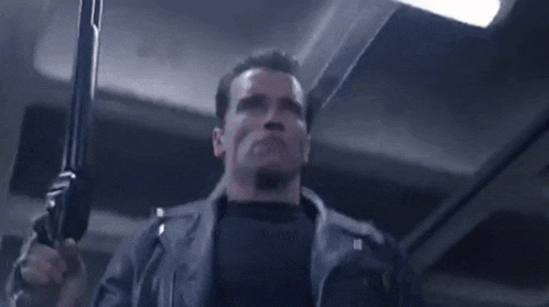 arnold schwarzenegger is holding a gun in a dark room with the words we written above him