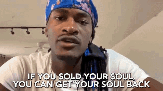 a man wearing a blue headband is talking about selling your soul and getting your soul back .