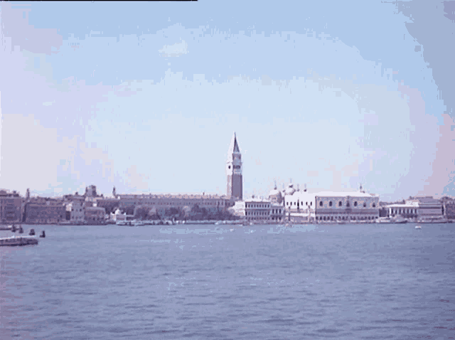 a large body of water with a clock tower in the background