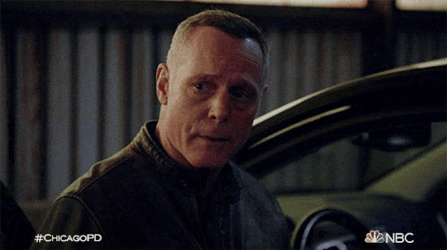 a man is standing in front of a car with the hashtag #chicagopd