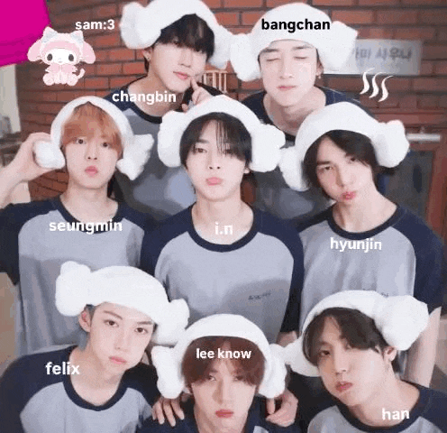 a group of young men are standing next to each other wearing towels on their heads .