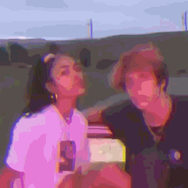 a man and a woman are posing for a picture and the woman is wearing a pink shirt with the number 9 on it