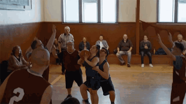 a group of basketball players are playing a game and one of them has the number 2 on his jersey