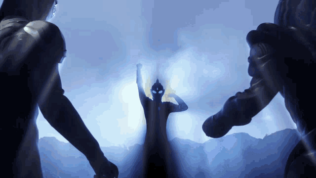 a silhouette of a person with their arm up