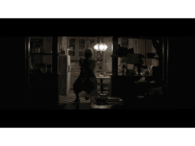 the end of a movie is shown with a woman holding a broom