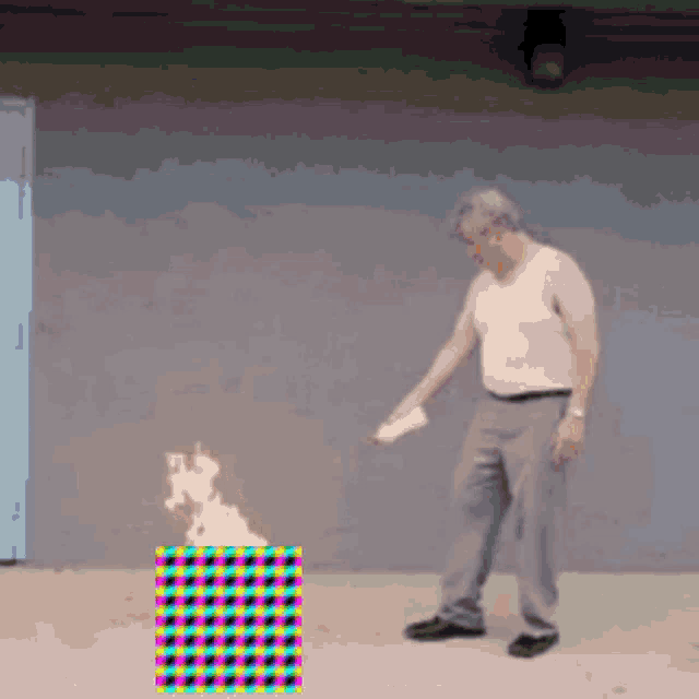 a man in a white tank top is standing in front of a colorful checkered box