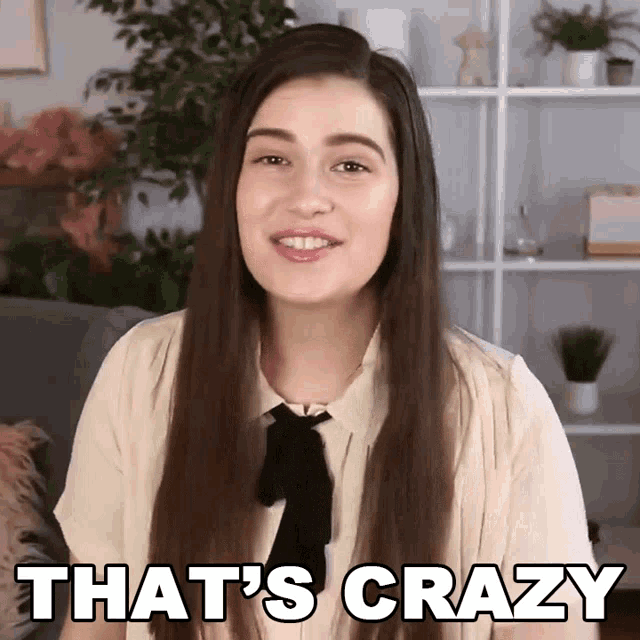 a woman says that 's crazy in front of a bookshelf