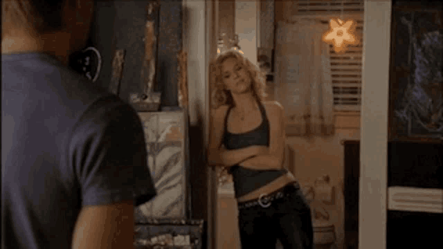 a man and a woman are standing in a room with a star hanging from the ceiling .