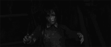 a black and white photo of a woman surrounded by fire .