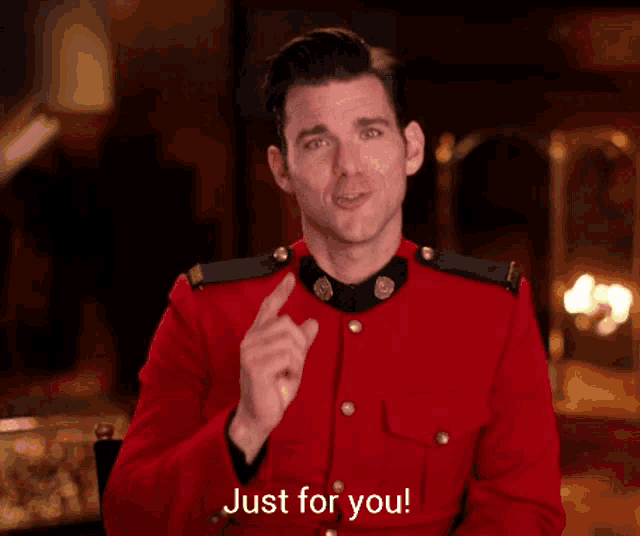 a man in a red uniform says just for you while pointing