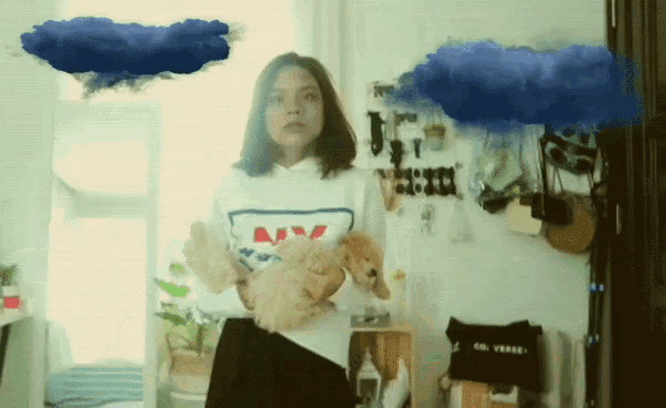 a woman holding a puppy wearing a sweatshirt that says ny