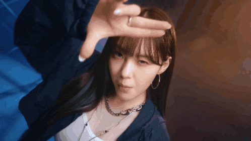 a woman with a ring on her finger is making a face