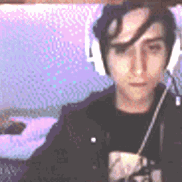 a pixelated image of a man wearing headphones and a black shirt