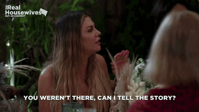 a woman sitting at a table talking to another woman with the words " you weren 't there can i tell the story "