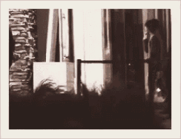 a blurry photo of a person standing in front of a door