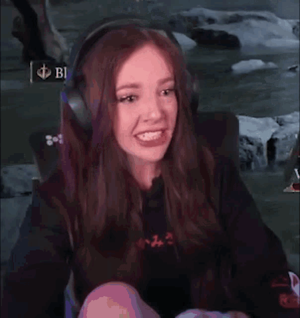 a woman is wearing headphones and making a funny face .