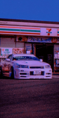 a car is parked in front of a 7 eleven