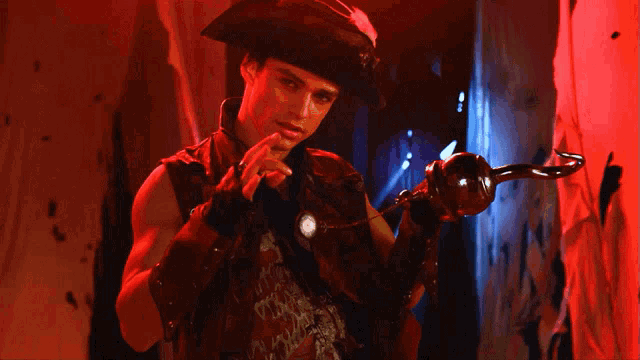 a man in a pirate costume holds a hook