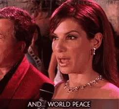 a woman with red hair is talking into a microphone with the words " and world peace " above her