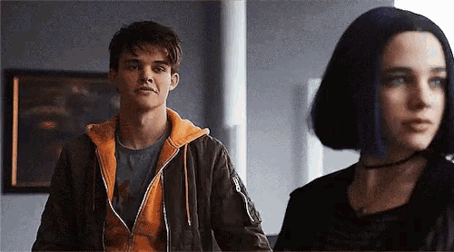 a man and a woman standing next to each other in a room