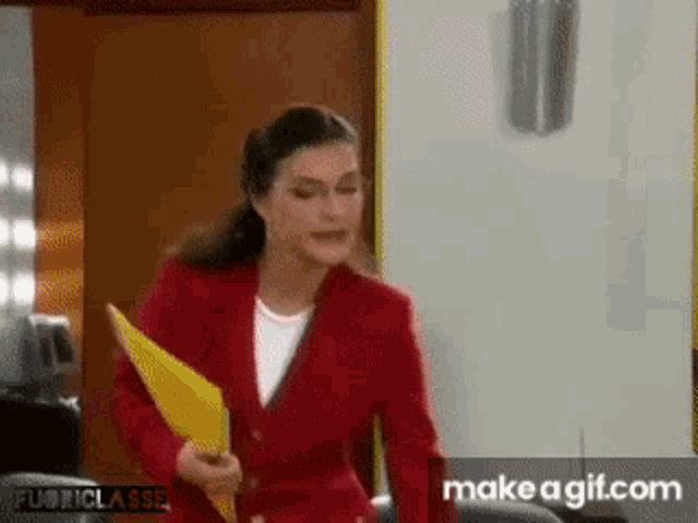 a woman in a red suit holding a yellow folder