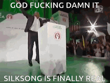 a man stands at a podium with his arm in the air and says god fucking damn it silksong is finally real ..