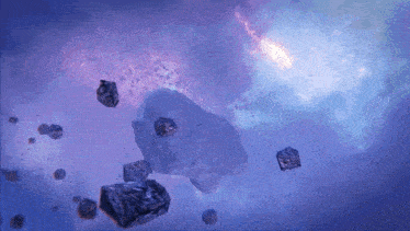 a cluster of rocks are flying through a blue sky