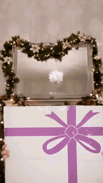 a white gift box with a purple bow