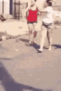a blurry picture of two people fighting on the street