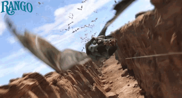 a poster for rango shows a dragon flying over a desert