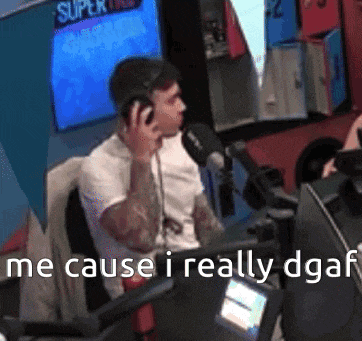 a man sitting in front of a microphone with the words " he cause i really dgaf " written below him