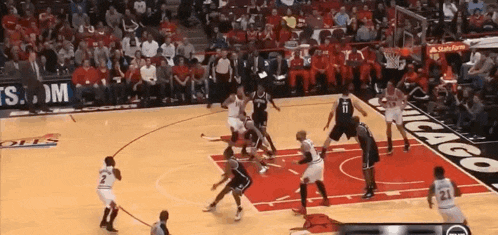 a basketball game is being played on a court with a chicago sign on the floor