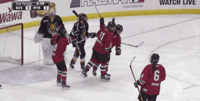 a hockey game is being played in front of a wawa ad