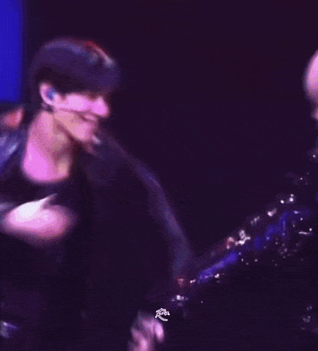 a blurry picture of two people dancing on stage