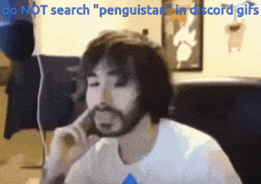 a man with a beard is talking on a phone with the words do not search " penguistan " in discord gifs