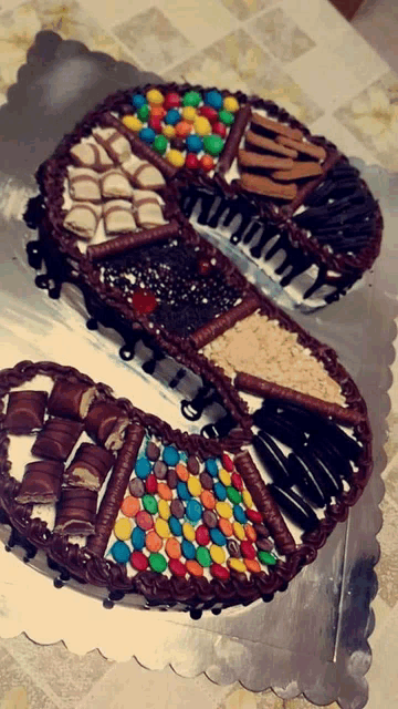 a chocolate cake with m & m 's on it