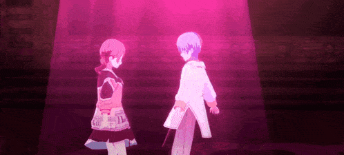 a man and a woman are standing next to each other in a pink light .