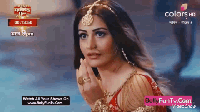 a woman in a red dress with a ring on her finger is on a screen that says colors hd