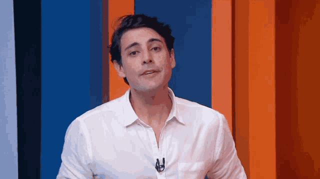 a man wearing a white shirt has a microphone in his pocket