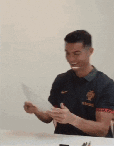 a man wearing a shirt that says ' portugal ' on the front